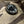 Black button with 'LEFT' text on a camouflage fabric background