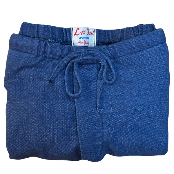 Folded blue pants with a label on a white background