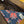 Close-up of a denim pocket with floral pattern and brand label on a jacket.