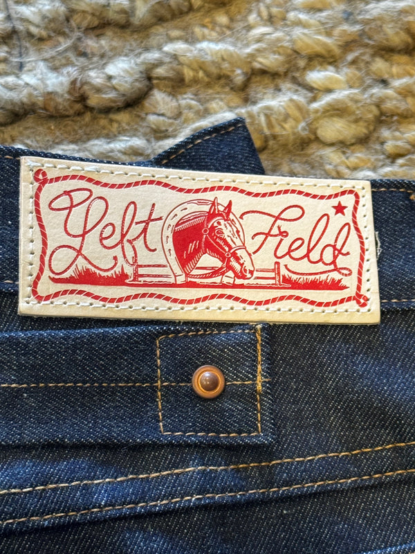 Close-up of a LF label on a denim jacket with a textured background.