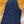 Folded blue jeans on a wooden floor