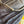 Close-up of dark indigo denim fabric showing the texture of the twill weave and a yellow-orange contrast stitch along the pocket edge.