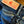 Close-up of dark blue denim jeans showing the waistband, pocket, and a tan leather brand patch with red script reading 'Left Field'.