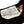 Close-up of a Left Field label on a black and white striped shirt with an American flag patch.