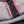 Close-up of denim fabric with red stitching detail