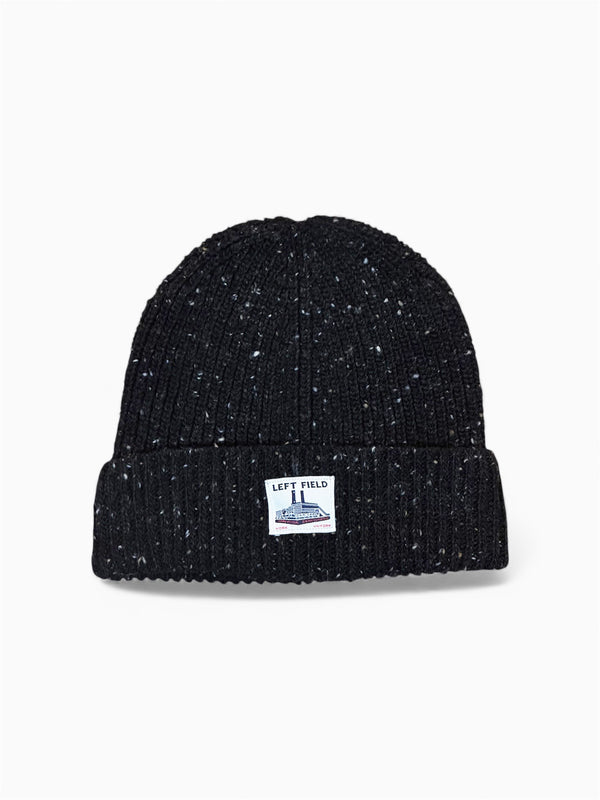 Black knit beanie with a brand label on a white background