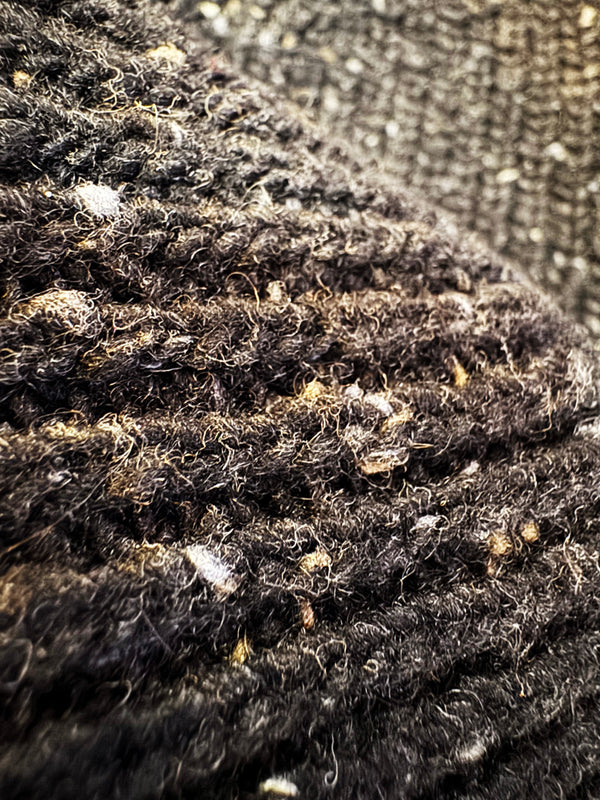 Close-up of textured fabric with a focus on texture and color variations.