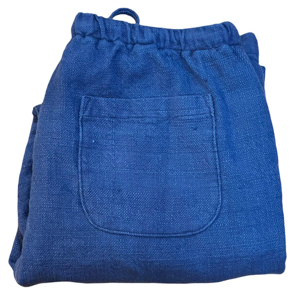 Folded blue denim pants with a pocket on a white background
