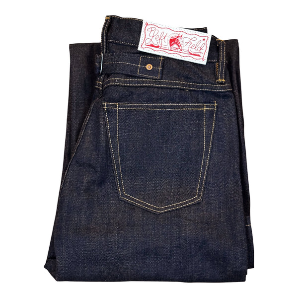 A folded pair of dark indigo denim jeans showing the back pocket with contrast yellow stitching and a white brand label that reads 'Ride or Die' with a red horse logo, on a plain white background.